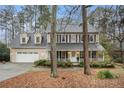 Charming two-story traditional home boasts a 2-car garage and inviting front porch with black shutters at 515 Lees Sw Trce, Marietta, GA 30064