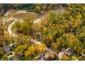 Aerial view of a residential community nestled in a wooded area with winding roads at 4412 Brookview Se Dr, Atlanta, GA 30339