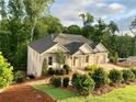 Craftsman style home with white brick exterior, landscaped yard, and a spacious driveway at 4412 Brookview Se Dr, Atlanta, GA 30339