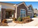 Inviting front porch with brick columns and comfortable seating area at 4980 Pleasantry Nw Way, Acworth, GA 30101