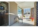 Covered front porch with wooden door and charming wreath at 4980 Pleasantry Nw Way, Acworth, GA 30101
