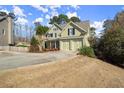 Charming two-story home features a manicured front yard and a spacious driveway leading to a two-car garage at 5025 Hidden Ct, Cumming, GA 30040