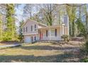 Tan house with red door, attached garage, and landscaped yard at 3794 Whaley Ct, Snellville, GA 30039