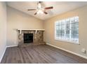 Living room with stone fireplace and wood-look floors at 3794 Whaley Ct, Snellville, GA 30039