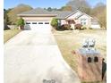 Brick house with a three-car garage and lion statues at 1419 Gates Mill Walk, Lawrenceville, GA 30045