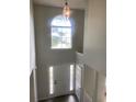 Bright foyer features a high ceiling, a large arched window, and neutral wall paint at 2080 Winding Crossing Trl, Fairburn, GA 30213