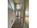 Bright entryway with hardwood floors, and a staircase, leading into carpeted living space at 2080 Winding Crossing Trl, Fairburn, GA 30213