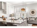 Modern kitchen with large island, breakfast nook, and white shaker cabinets at 120 Clover Ct, Roswell, GA 30075