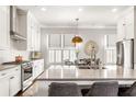 Bright kitchen featuring a large island, white cabinets, and stainless steel appliances at 120 Clover Ct, Roswell, GA 30075
