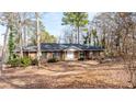 Brick ranch house nestled in a wooded area at 4653 Flat Bridge Sw Rd, Stockbridge, GA 30281