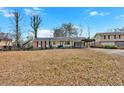 Ranch house with carport, mature trees, and yard at 2401 Prestige Valley Ct, Morrow, GA 30260