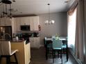 Kitchen with breakfast nook and white cabinets at 110 Sampson Ct, Covington, GA 30016
