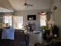 Spacious living room with hardwood floors, comfortable seating, and large TV at 110 Sampson Ct, Covington, GA 30016