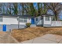 Newly renovated house featuring a modern exterior, fresh landscaping, and a spacious driveway at 4175 Danforth Sw Rd, Atlanta, GA 30331