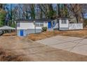 Newly renovated house featuring a modern exterior, fresh landscaping, and a spacious driveway at 4175 Danforth Sw Rd, Atlanta, GA 30331