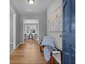 Light and airy entryway with light wood floors and a blue door at 6666 Briarcliff Dr, Douglasville, GA 30135