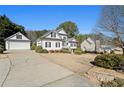 Home with attached two-car garage and a long driveway at 164 Castlewood Rd, Tyrone, GA 30290