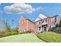 View of home's brick facade and manicured lawn, highlighting its curb appeal and architectural design at 2025 Fife Ridge Ct, Roswell, GA 30075