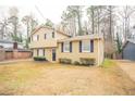 Two-story house with beige siding, dark-blue shutters, and a yard at 2211 Green Forrest Dr, Decatur, GA 30032