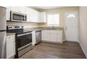 Renovated kitchen with stainless steel appliances and granite countertops at 2211 Green Forrest Dr, Decatur, GA 30032