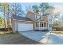 Two-story house with gray siding, white garage door, and a front porch at 3088 Fox Chase Ct, Snellville, GA 30039