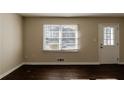 Living room with hardwood floors, large window, and neutral walls at 3582 Swallow Ln, Decatur, GA 30032