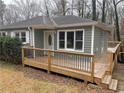 Charming single-story home with gray siding and wooden deck; a cozy outdoor space at 6070 Blackhawk Se Trl, Mableton, GA 30126