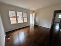 Bright living room featuring hardwood floors, white walls, and lots of natural light at 6070 Blackhawk Se Trl, Mableton, GA 30126
