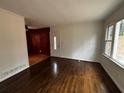 Spacious living room with hardwood floors, white walls, and open access to other rooms at 6070 Blackhawk Se Trl, Mableton, GA 30126