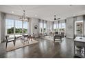 Open living room with hardwood floors and large windows at 244 Castleberry Station Sw Dr, Atlanta, GA 30313