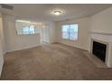 Spacious living room featuring a fireplace and carpet at 1427 Alcovy Falls Dr, Lawrenceville, GA 30045