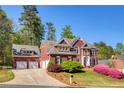 Beautiful brick home with a three car garage and a landscaped front yard at 701 Vinings Estates Se Dr, Smyrna, GA 30126