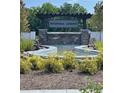 Community entrance featuring stone pillars, water feature, and attractive landscaping, welcomes residents and guests at 391 Lincoln St, Woodstock, GA 30188