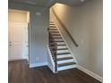 Inviting staircase with wood and iron details leading to the upper level of this newly constructed home at 391 Lincoln St, Woodstock, GA 30188