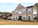 Two-story brick home with a large front yard and landscaping at 3111 Green Gate Se Way, Conyers, GA 30013