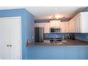 Bright kitchen features modern appliances, white cabinets, and functional bar area for casual dining at 8045 Woodlake Dr, Riverdale, GA 30274