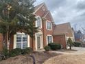 Two-story home with brick facade, landscaping, and a large tree at 1142 Drewsbury Se Ct, Smyrna, GA 30080