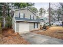 Two-story house with gray siding, red door, and attached garage at 6179 Dana Ct, Lithonia, GA 30058
