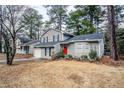 Gray sided two story house with red front door and attached garage at 6179 Dana Ct, Lithonia, GA 30058