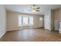 Spacious living room with hardwood floors, bay window, and ceiling fan at 6179 Dana Ct, Lithonia, GA 30058