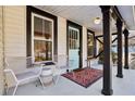 Front porch features two white chairs and a colorful rug at 1608 Carroll Nw Dr, Atlanta, GA 30318