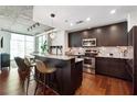Modern kitchen featuring granite countertops, stainless steel appliances, and an island with seating for casual dining at 250 Pharr Rd # 1707, Atlanta, GA 30305