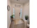 Bright and airy entryway with LVP flooring, a neutral color palette, and a decorative mirror at 4940 Parke Brook Dr, Acworth, GA 30101