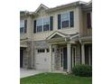 Tan townhome with stone accents, two-car garage, and landscaping at 4940 Parke Brook Dr, Acworth, GA 30101