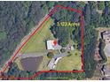 Aerial view of the 3.123 acre lot with home, pond and mature trees at 6585 Queen Mill Se Rd, Mableton, GA 30126