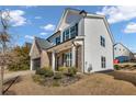 Two-story home with brick and white accents, landscaping, and a driveway at 210 Omega Ct, Dallas, GA 30157