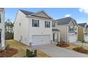 Two-story house with white siding, gray accents, and a two-car garage at 12029 Conrad Circle, Hampton, GA 30228