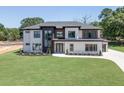 Modern two-story home with white brick and a landscaped lawn at 553 Versailles Dr, Auburn, GA 30011