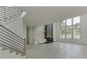 Spacious living room with hardwood floors, fireplace, and large windows at 553 Versailles Dr, Auburn, GA 30011