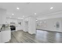 Modern kitchen with white cabinets, granite counters, and gray vinyl flooring at 5774 Forest Dr, Acworth, GA 30102